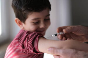 Doctor giving child patient injection